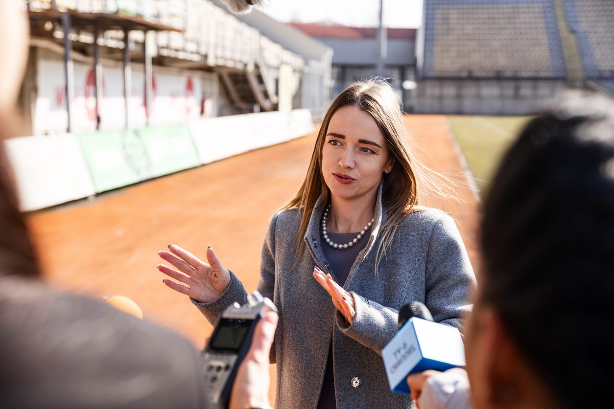 Two organization representative give interview outside