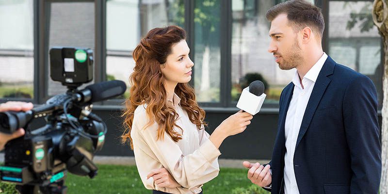 Beautiful,Serious,Female,News,Reporter,Taking,Interview,With,Businessman title=